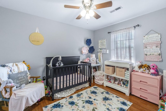 8202 Iris Rd, Chattanooga, TN 37421 - bedroom with a nursery area, wood finished floors, and a ceiling fan