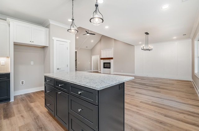 408 Harsh Ln, Castalian Springs, TN 37031 - kitchen featuring white cabinets, light wood-style floors, decorative light fixtures, a ceiling fan, and light stone countertops