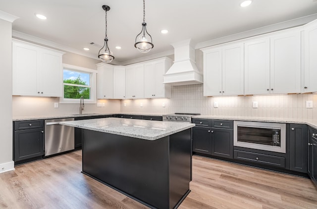 408 Harsh Ln, Castalian Springs, TN 37031 - kitchen featuring stainless steel appliances, premium range hood, white cabinets, a center island, and hanging light fixtures