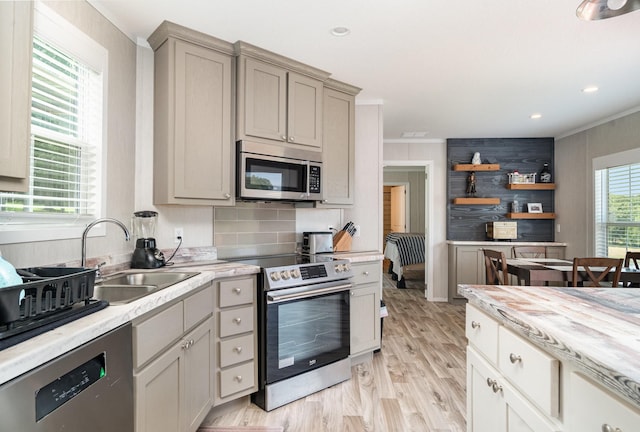 1640 Eno Rd, Dickson, TN 37055 - kitchen with appliances with stainless steel finishes, crown molding, light countertops, decorative backsplash, and light wood-style floors