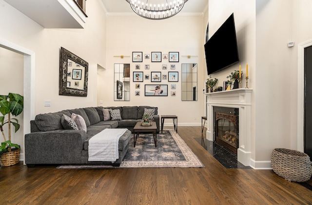 1640 Eno Rd, Dickson, TN 37055 - living area with dark wood-type flooring, a chandelier, ornamental molding, a fireplace with flush hearth, and a high ceiling