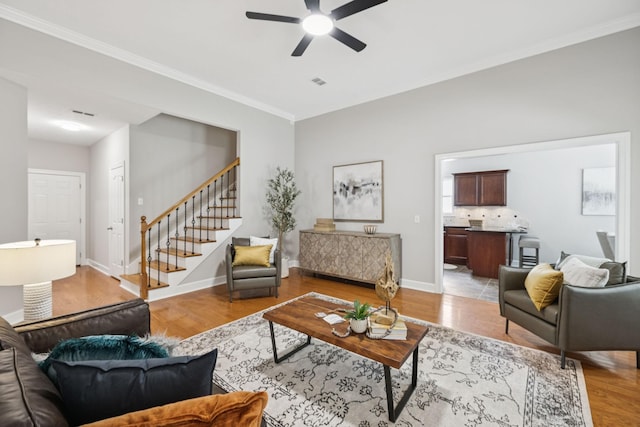 4613 Scottish Dr, Murfreesboro, TN 37128 - living room featuring stairway, a ceiling fan, light wood-type flooring, and ornamental molding