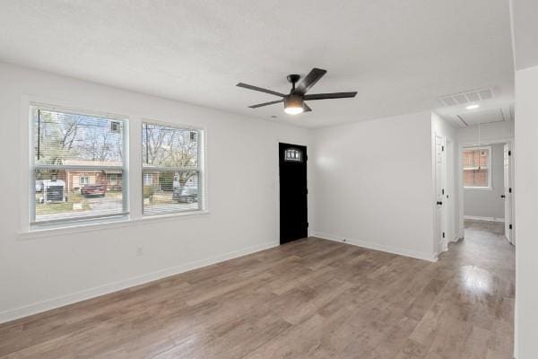 3211 Mayer Ln, Nashville, TN 37218 - empty room with attic access, light wood-style flooring, ceiling fan, and healthy amount of natural light