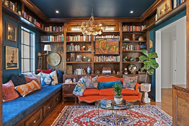 1049 Holly Tree Gap Rd, Brentwood, TN 37027 - sitting room with wood finished floors, a chandelier, and built in shelves