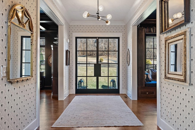1049 Holly Tree Gap Rd, Brentwood, TN 37027 - foyer entrance featuring wallpapered walls, crown molding, a chandelier, dark wood-type flooring, and healthy amount of natural light