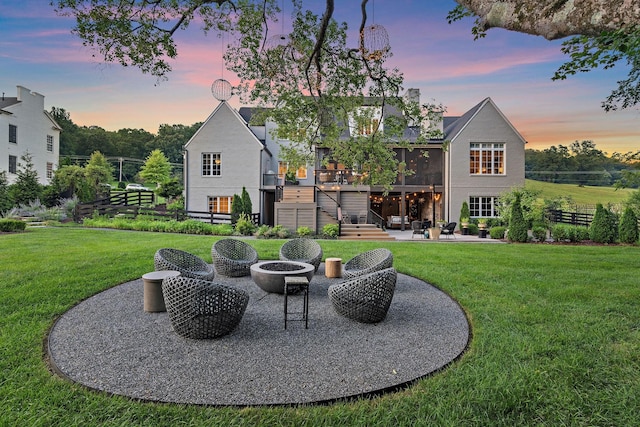 1049 Holly Tree Gap Rd, Brentwood, TN 37027 - back of property at dusk with a fire pit, a patio area, stairs, and a wooden deck