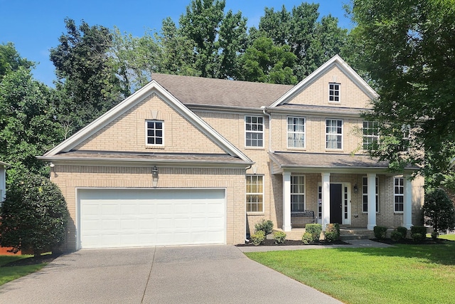 611 Heritage Dr, Mount Juliet, TN 37122 - view of front of home featuring driveway, a porch, a front lawn, and brick siding