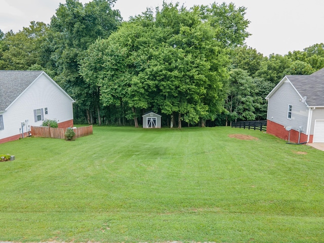 216 Desperado Ave, Pulaski, TN 38478 - view of yard with a garage, a storage shed, and view of wooded area
