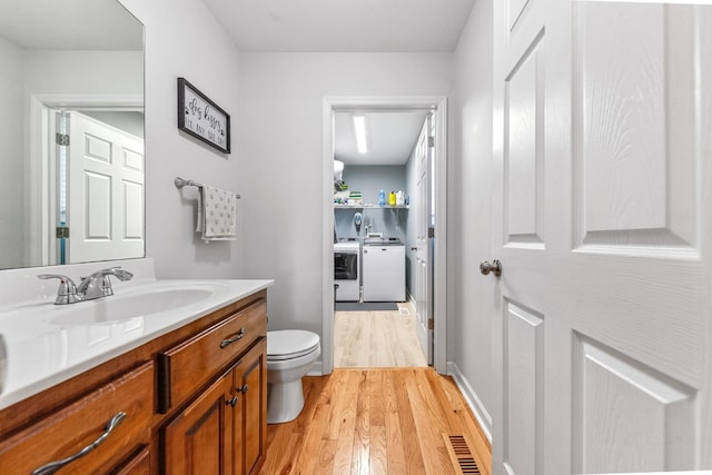 216 Desperado Ave, Pulaski, TN 38478 - bathroom featuring separate washer and dryer, wood finished floors, and vanity