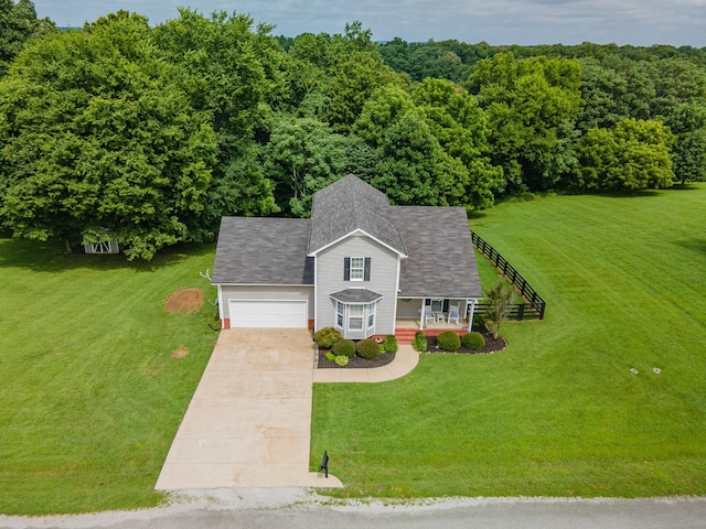 216 Desperado Ave, Pulaski, TN 38478 - view of front of home featuring driveway, covered porch, a garage, a front lawn, and a shingled roof