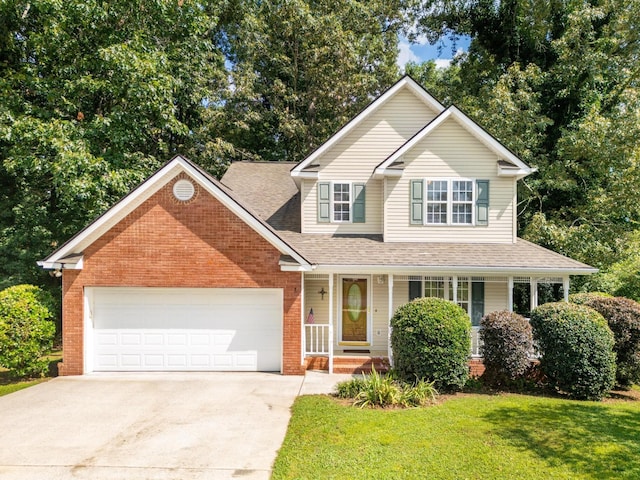 140 Janes Way NE, Cleveland, TN 37323 - traditional home with driveway, an attached garage, brick siding, a front lawn, and covered porch