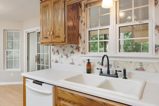 140 Janes Way NE, Cleveland, TN 37323 - kitchen with dishwasher, brown cabinetry, light countertops, and light wood finished floors