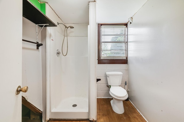 201 Sterry Ct, Antioch, TN 37013 - bathroom featuring wood finished floors, a stall shower, and tile walls