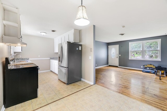 201 Sterry Ct, Antioch, TN 37013 - kitchen featuring stainless steel fridge with ice dispenser, white cabinets, light tile patterned floors, and light countertops