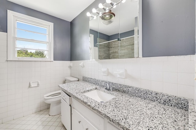 201 Sterry Ct, Antioch, TN 37013 - bathroom with tiled shower, vanity, tile patterned flooring, and tile walls