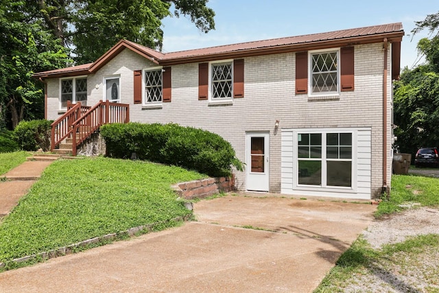 201 Sterry Ct, Antioch, TN 37013 - view of front of home featuring a front yard, brick siding, and a patio