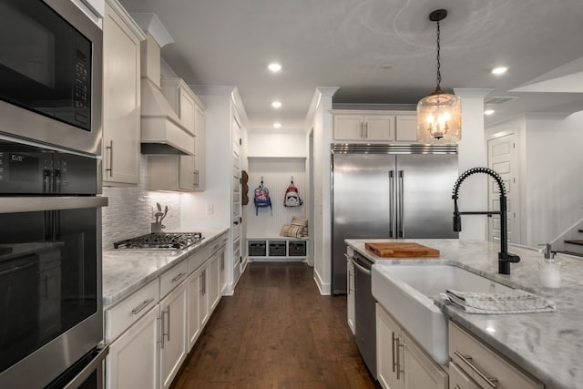 5726 Bridgemore Blvd, Murfreesboro, TN 37129 - kitchen with appliances with stainless steel finishes, premium range hood, decorative backsplash, white cabinetry, and recessed lighting