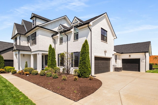 5726 Bridgemore Blvd, Murfreesboro, TN 37129 - view of front of property with concrete driveway, brick siding, an attached garage, and board and batten siding