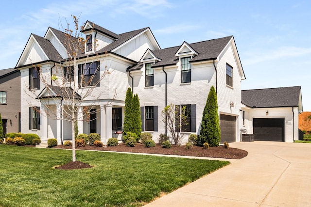 5726 Bridgemore Blvd, Murfreesboro, TN 37129 - view of front facade with concrete driveway, brick siding, a front lawn, board and batten siding, and roof with shingles