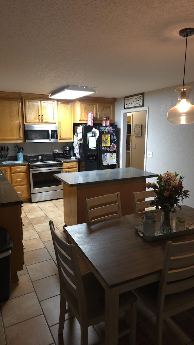 145 Michelle Ln, Winchester, TN 37398 - dining area featuring a textured ceiling and light tile patterned floors