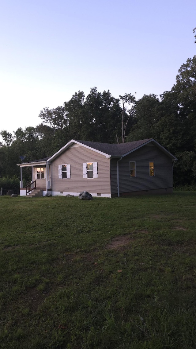 145 Michelle Ln, Winchester, TN 37398 - back of house featuring a lawn, crawl space, and view of wooded area