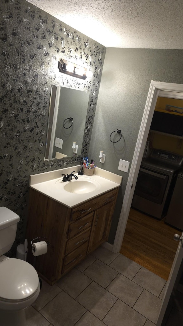 145 Michelle Ln, Winchester, TN 37398 - bathroom featuring washer / dryer, tile patterned flooring, vanity, and a textured ceiling