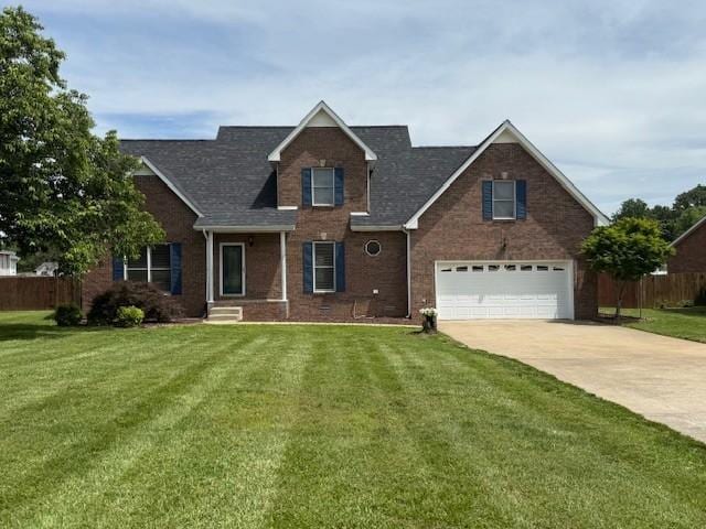 2750 Shepherds Ct, Woodlawn, TN 37191 - traditional-style house featuring an attached garage, brick siding, concrete driveway, and a shingled roof