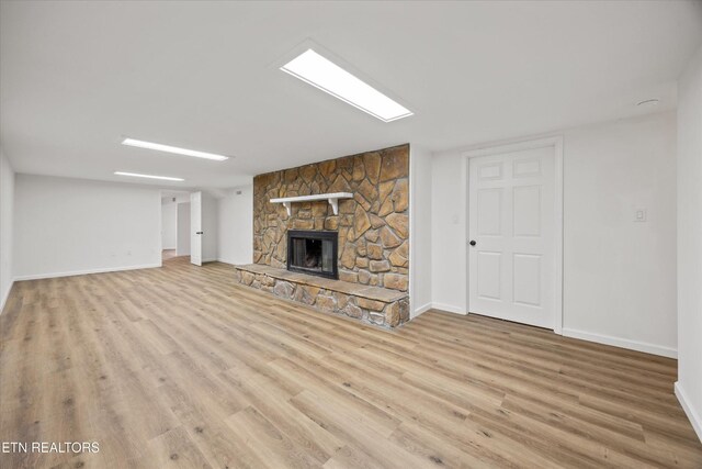 1701 Talbott Kansas Rd, Talbott, TN 37877 - unfurnished living room featuring wood finished floors and a stone fireplace