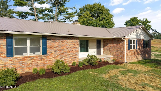 1701 Talbott Kansas Rd, Talbott, TN 37877 - view of front of home with a front lawn, brick siding, and a metal roof