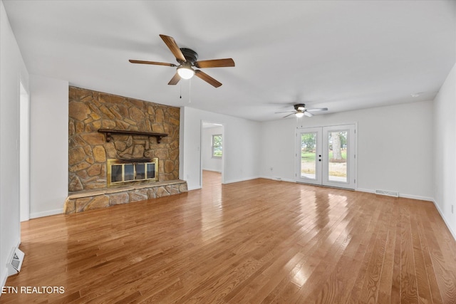1701 Talbott Kansas Rd, Talbott, TN 37877 - unfurnished living room with ceiling fan, light wood-type flooring, and a stone fireplace