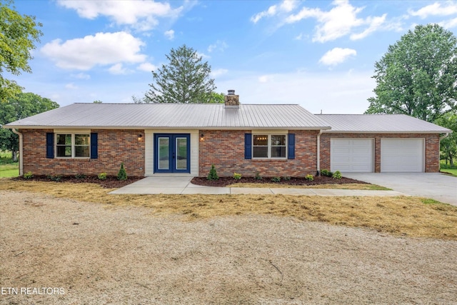 1701 Talbott Kansas Rd, Talbott, TN 37877 - single story home featuring french doors, a garage, concrete driveway, a chimney, and a metal roof