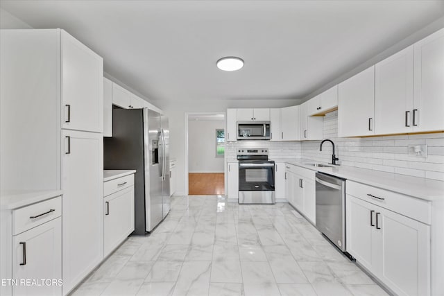 1701 Talbott Kansas Rd, Talbott, TN 37877 - kitchen with stainless steel appliances, light marble finish floors, light countertops, backsplash, and white cabinetry