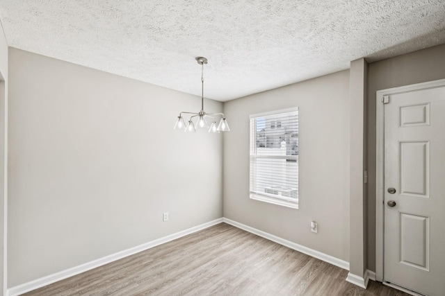5428 Cedar Ash Xing, Antioch, TN 37013 - unfurnished dining area featuring wood finished floors, a chandelier, and a textured ceiling