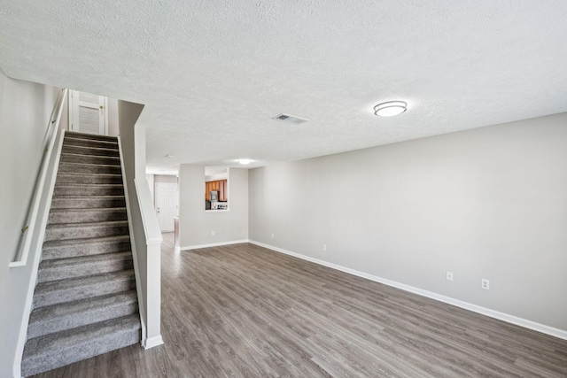 5428 Cedar Ash Xing, Antioch, TN 37013 - below grade area featuring dark wood-style floors, stairs, and a textured ceiling