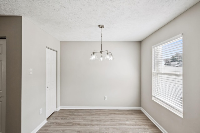 5428 Cedar Ash Xing, Antioch, TN 37013 - unfurnished dining area with a chandelier, light wood-style floors, and a textured ceiling