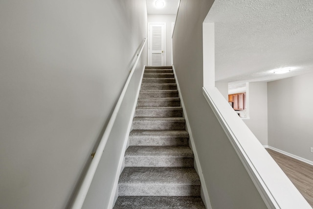 5428 Cedar Ash Xing, Antioch, TN 37013 - stairs with a textured ceiling and wood finished floors