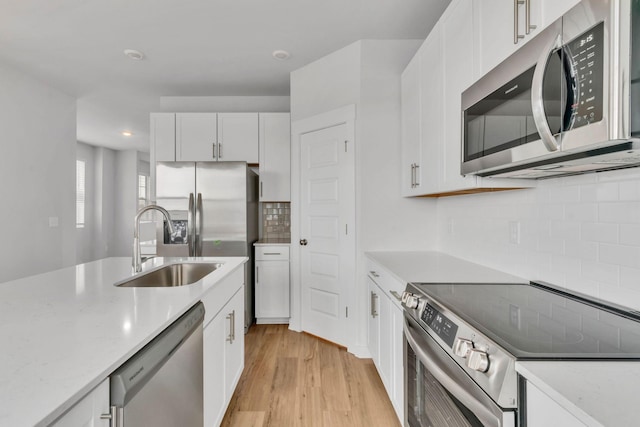 510 Hinton St, Lebanon, TN 37090 - kitchen featuring stainless steel appliances, backsplash, white cabinets, light wood-style flooring, and recessed lighting