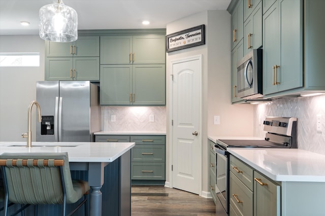 509 Eagleview Dr, Eagleville, TN 37060 - kitchen featuring stainless steel appliances, green cabinetry, light countertops, decorative backsplash, and dark wood finished floors