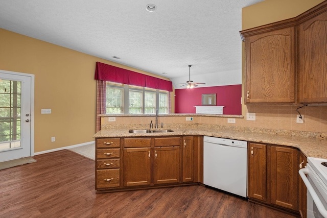 225 Cobblestone Lndg, Mount Juliet, TN 37122 - kitchen featuring white appliances, dark wood-style flooring, brown cabinetry, a peninsula, and a textured ceiling