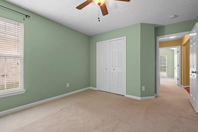 225 Cobblestone Lndg, Mount Juliet, TN 37122 - unfurnished bedroom featuring carpet flooring, a closet, a textured ceiling, and a ceiling fan