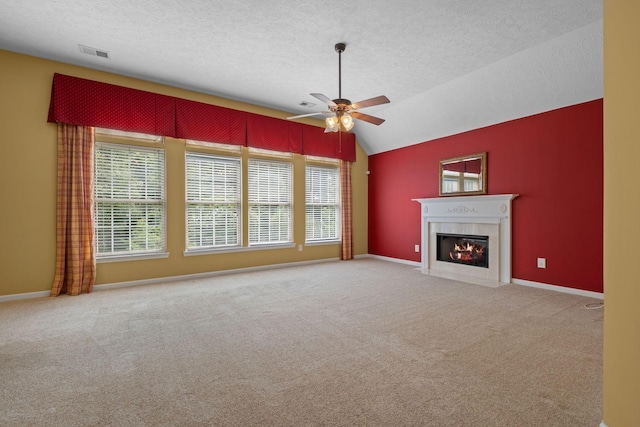 225 Cobblestone Lndg, Mount Juliet, TN 37122 - unfurnished living room with ceiling fan, plenty of natural light, a textured ceiling, a fireplace with flush hearth, and carpet floors
