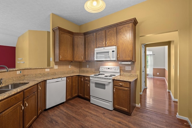 225 Cobblestone Lndg, Mount Juliet, TN 37122 - kitchen featuring white appliances, decorative backsplash, dark wood-style floors, light stone countertops, and a textured ceiling
