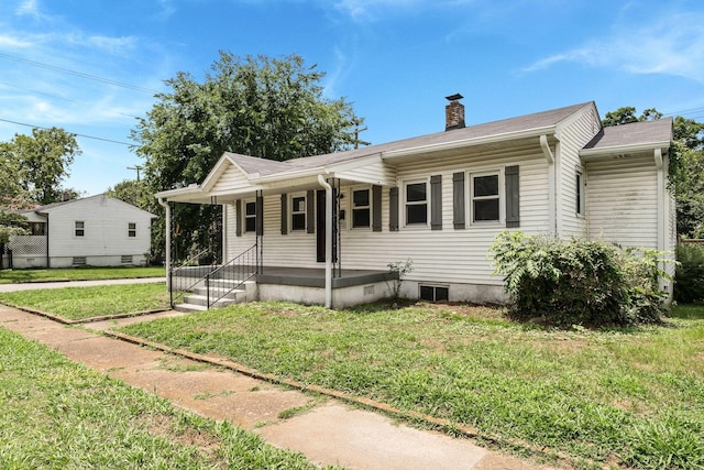 1410 Debow St, Old Hickory, TN 37138 - view of front of home featuring a chimney, a front lawn, and covered porch
