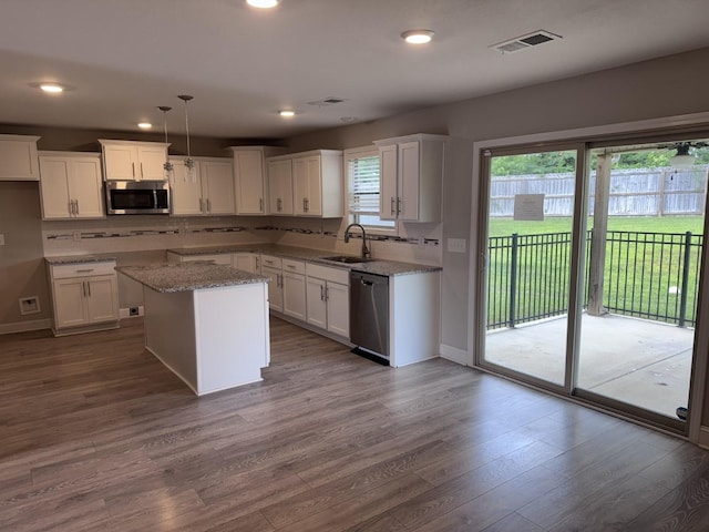 1175 Ewing Way, Clarksville, TN 37043 - kitchen with appliances with stainless steel finishes, dark wood-style floors, decorative backsplash, white cabinets, and recessed lighting