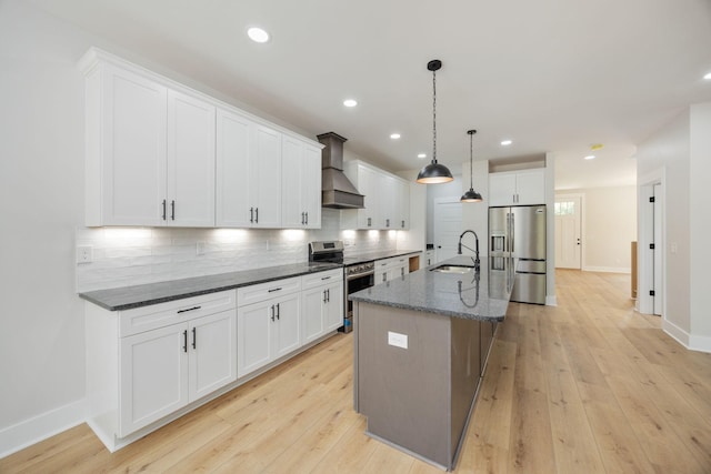 403 Boren St, Springfield, TN 37172 - kitchen featuring appliances with stainless steel finishes, wall chimney exhaust hood, backsplash, white cabinetry, and recessed lighting