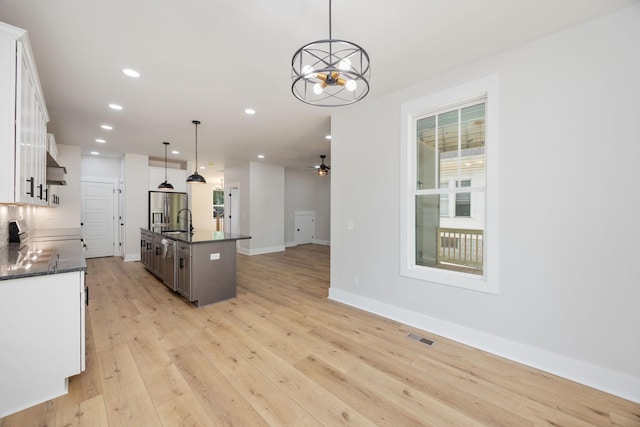 403 Boren St, Springfield, TN 37172 - kitchen with light wood finished floors, open floor plan, white cabinets, recessed lighting, and a chandelier