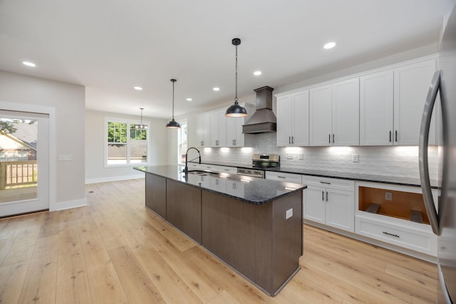 403 Boren St, Springfield, TN 37172 - kitchen featuring custom range hood, stainless steel appliances, backsplash, a center island with sink, and white cabinets