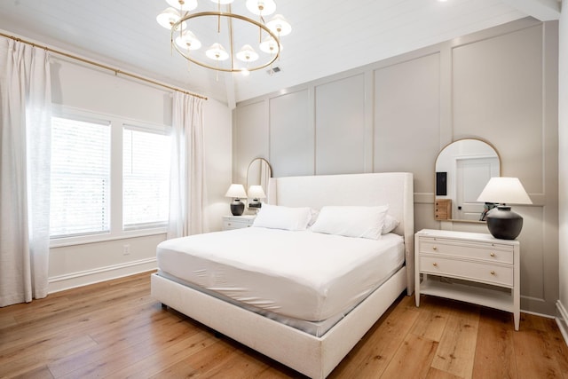 1015 Amelia Ct, Chattanooga, TN 37412 - bedroom with a chandelier, light wood-style floors, and a decorative wall