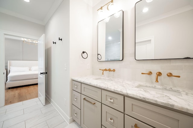 1015 Amelia Ct, Chattanooga, TN 37412 - ensuite bathroom featuring double vanity, ornamental molding, decorative backsplash, and recessed lighting