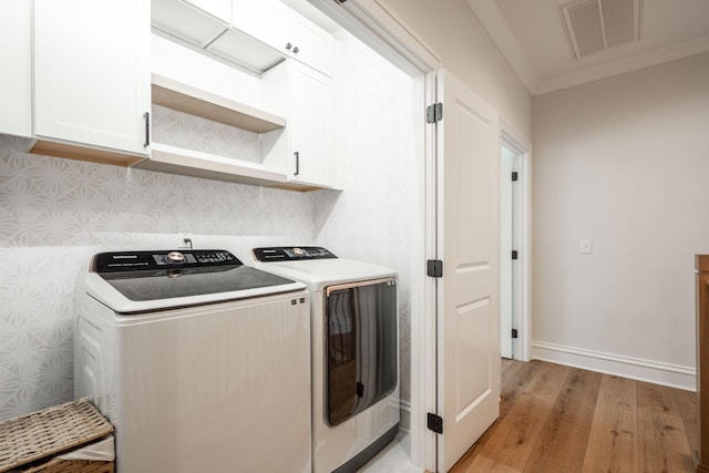 1015 Amelia Ct, Chattanooga, TN 37412 - laundry room with cabinet space, washer and dryer, and light wood-type flooring